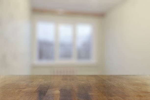 istock wooden table in the room with big windows 2250080392