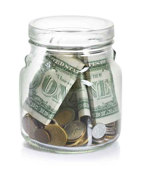 istock Glass jar with money isolated on white 2250080768