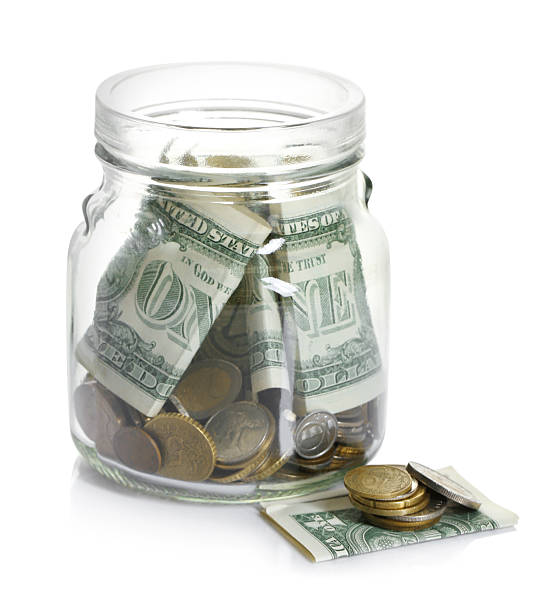 istock Glass jar with money isolated on white 2250080801