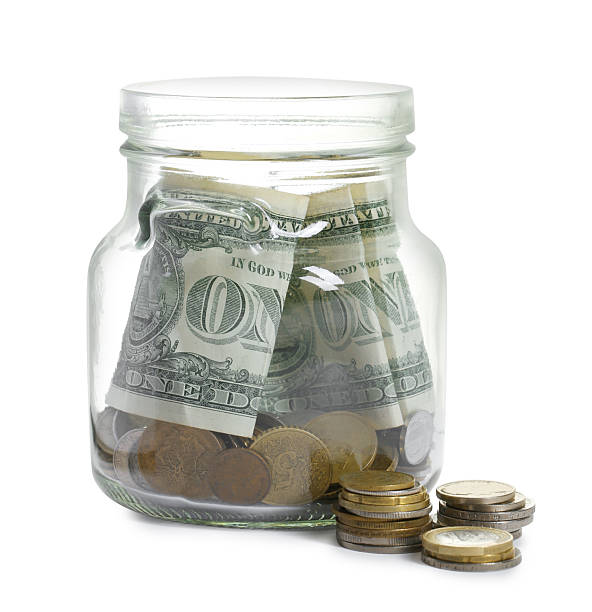 istock Glass jar with money isolated on white 2250080811