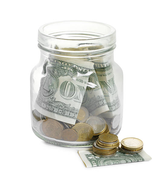 istock Glass jar with money isolated on white 2250080851