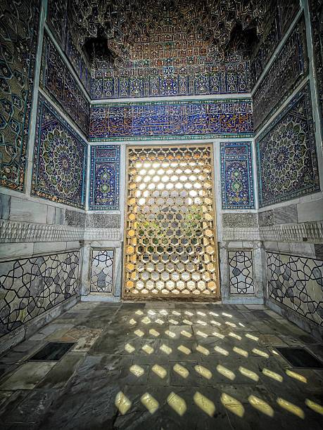 istock Room in Samarkand covered with blue Iranian-style tiles, with an ornate door casting patterned shadows on a marble floor, showcasing Timurid-era architecture in Uzbekistan. 2250081057