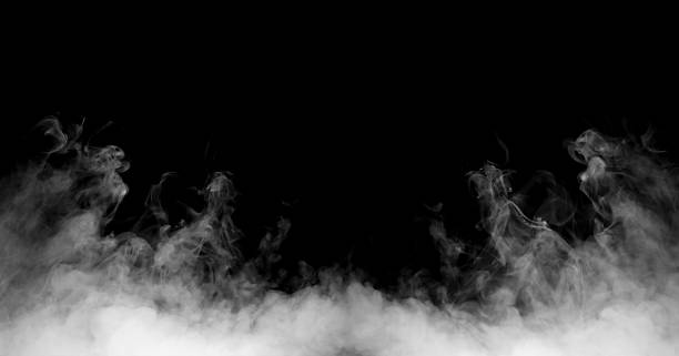 istock Dense white smoke drifting on a dark background creates a dramatic atmospheric texture, ideal for design overlays, cinematic effects, and creative compositions needing mist, fog, or vapor elements. 2250083563