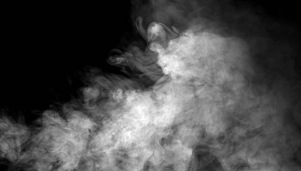 istock Dense white smoke drifting on a dark background creates a dramatic atmospheric texture, ideal for design overlays, cinematic effects, and creative compositions needing mist, fog, or vapor elements. 2250083575