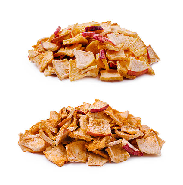 istock Dried apple slices stacked in two separate piles for healthy snacking 2250087589