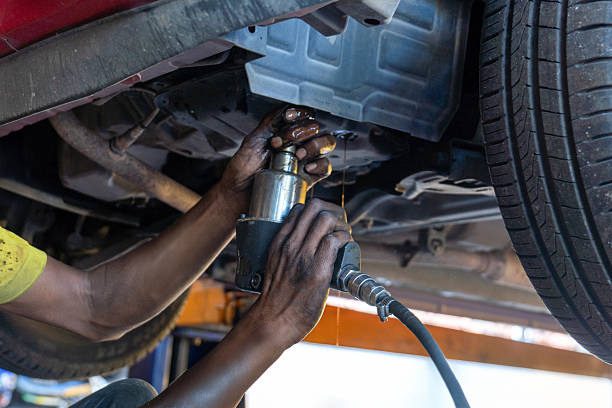 istock Auto mechanic draining transmission fluid from a vehicle during an ATF or Automatic Transmission Fluid oil change. 2250087605