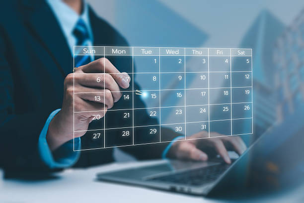 istock A business professional interacting with a futuristic digital calendar interface above a laptop, symbolizing scheduling, planning, productivity, and modern time-management in corporate workflow. 2250087835