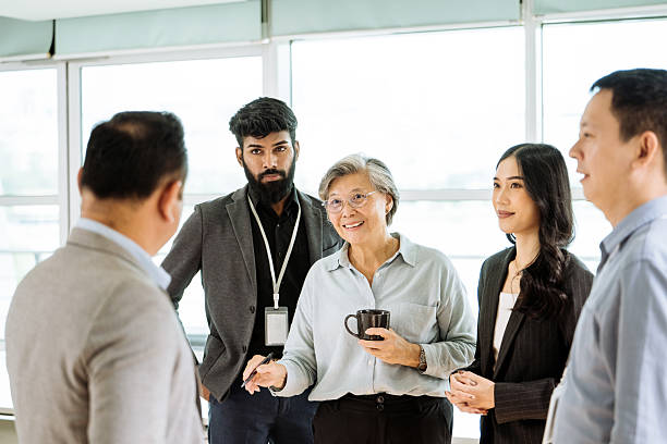 istock Diverse business people working together in modern office, and having a coffee break 2250088601