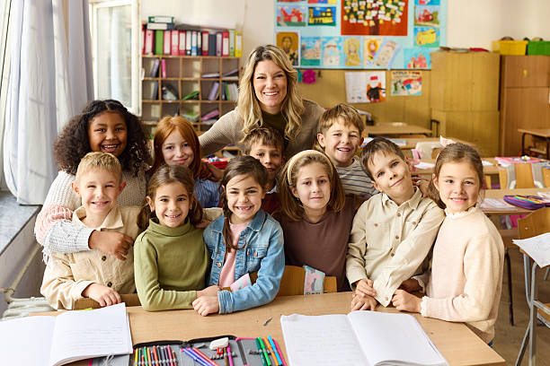 istock Happy teacher enjoying with her elementary students in the classroom. 2250089222