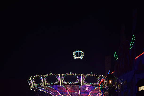 Mayen, Germany - October 11/2025: classic purple and pink lights on a flying chairs carousel, standing