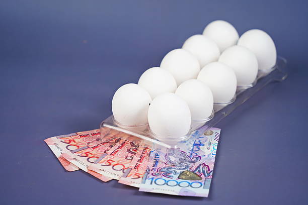 istock Eggs in a container tray on tenge banknotes on a paper background. 2250092952