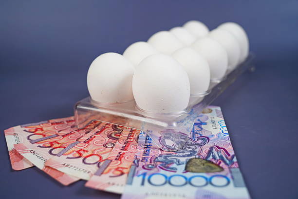 istock Eggs in a container tray on tenge banknotes on a paper background. 2250092963