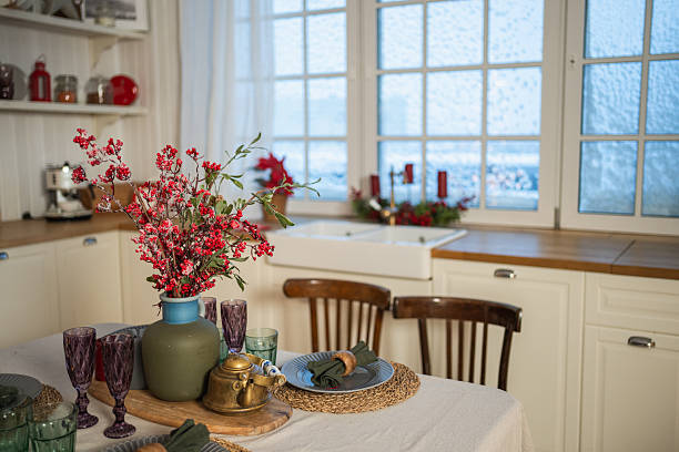 Classical Christmas decorated interior kitchen. Modern classic style interior design apartment dining with red frosty branches bouquet ornament Christmas decorations. Christmas eve at home