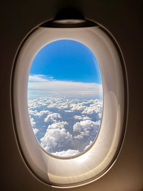 istock Clouds seen through the window of a passenger plane 2250096680