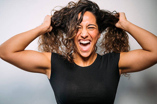 istock Stressed woman pulling hair screaming from frustration 2250098547