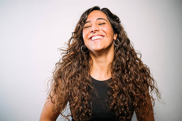 istock Happy young woman laughing with joyful expression 2250098557