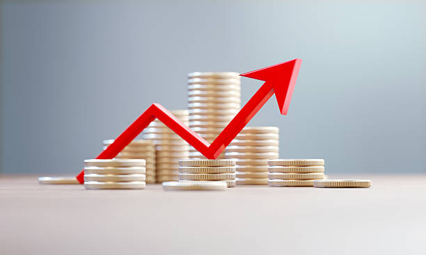istock Red Rising Arrow And Coins Stacks Before Defocused Background 2250098589