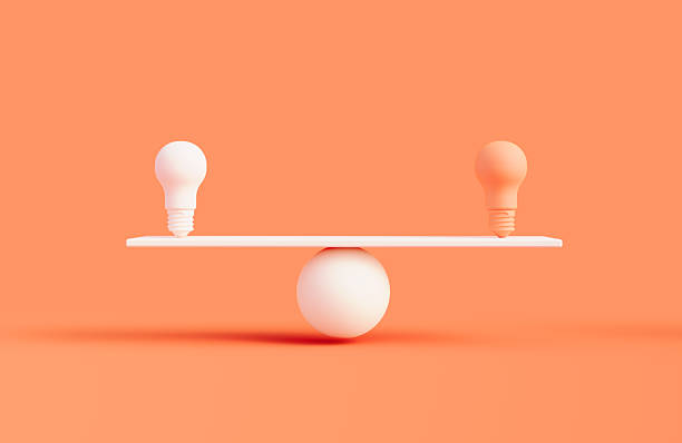 istock Orange And White Light Bulbs On A White Seesaw Over Orange Background 2250098628