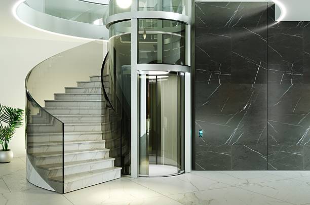 istock Title: Luxury Glass Elevator and Marble Spiral Staircase in Modern Interior Hall 2250099083