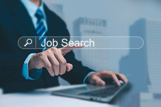 istock A business professional using a laptop and selecting a glowing job search bar, representing online recruitment, career searching, employment opportunities, and modern digital hiring processes. 2250106803