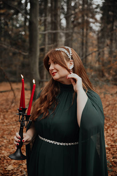 istock Woman Holding Red Candles in Forest 2250108779