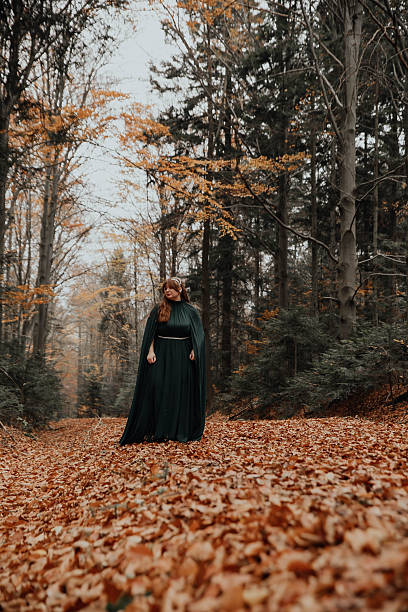 istock Woman Standing in Forest Clearing – Green Cloak 2250108968