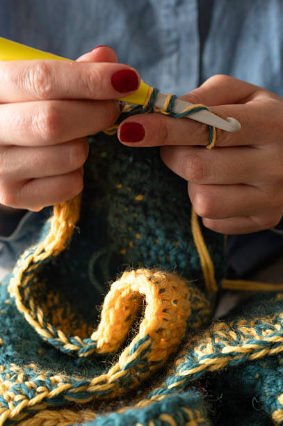 istock Hands Crocheting a Colorful Yarn Project 2250109611