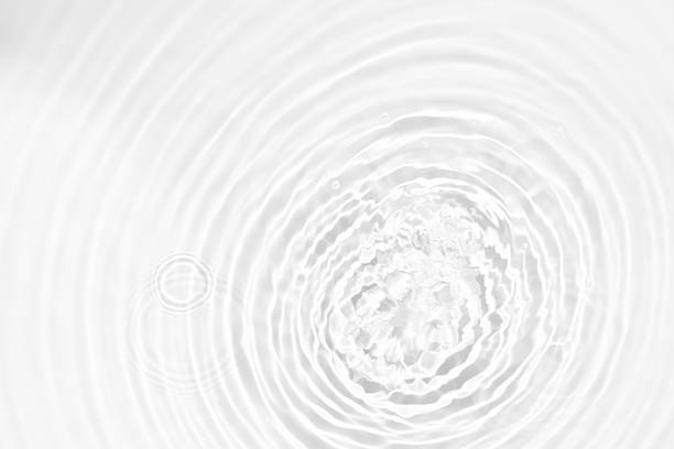 istock White water with ripples on the surface. Defocus blurred transparent white colored clear calm water surface texture with splashes and bubbles. Water waves with shining pattern texture background. 2250110784