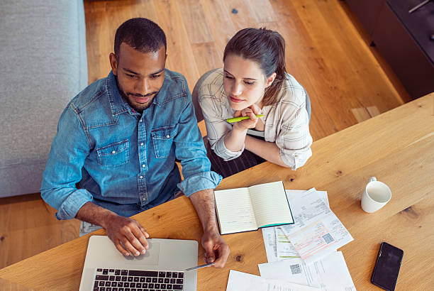 istock Diverse Couple Strategizing Home Finances at Comfortable Table 2250112398