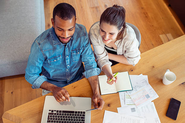 istock Joyful Couple Collaborating on Finance at Their Dining Table 2250112421
