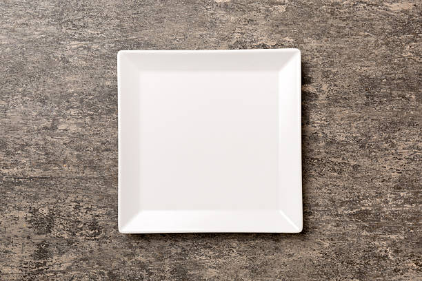 istock Top view of empty square plate on cement background. Empty space for your design 2250114603