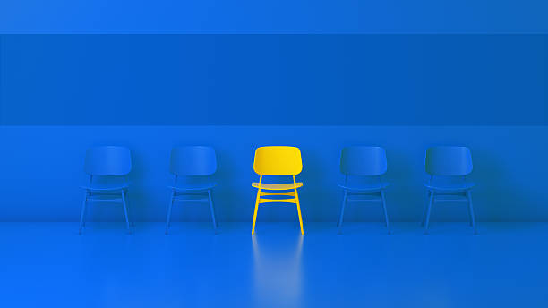 istock Unique Yellow Chair Standing Out Among Blue Chairs in Modern Minimalist Studio 2250117306