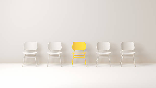 istock Yellow Chair Standing Out Among White Chairs in Minimalist Studio 2250117332