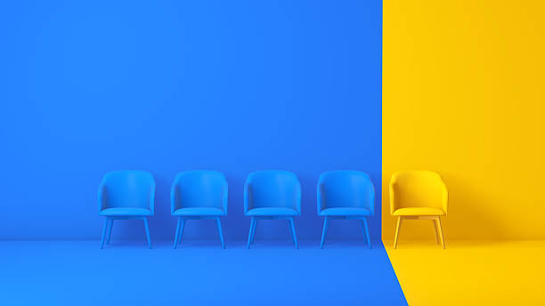 istock Yellow Chair Standing Apart from Blue Chairs in Minimal Two-Tone Studio 2250117345