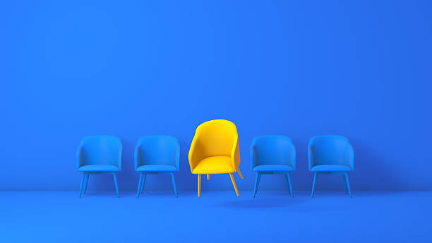 istock Unique Yellow Chair Standing Out Among Blue Chairs in Modern Minimalist Studio 2250117348