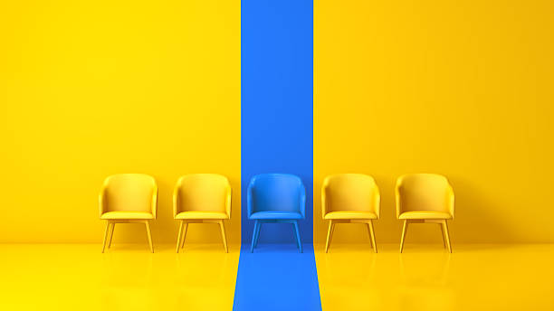 istock Blue Chair Among Yellow Chairs in Minimal Studio 2250117392