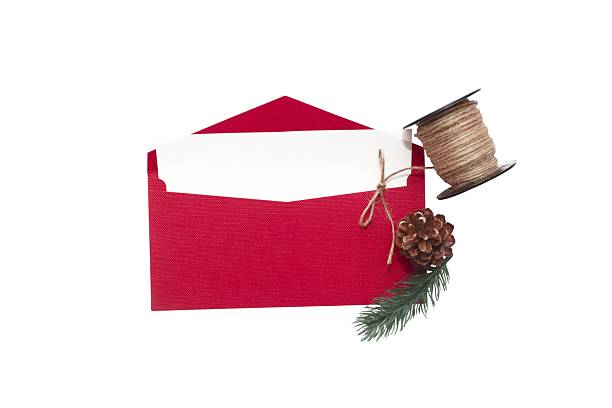 Red envelope with white card, pine branch, cone and twine, isolated on white background, festive and natural