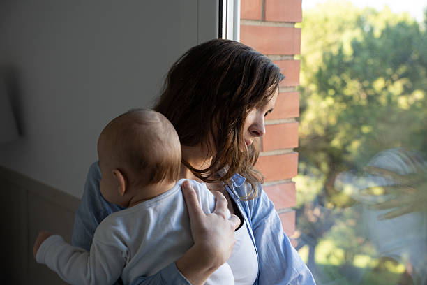 istock New mother experiencing sadness postpartum depression with baby 2250122646