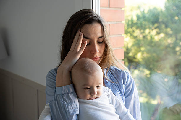 istock Exhausted mother caring for her newborn while facing postpartum depression 2250122685