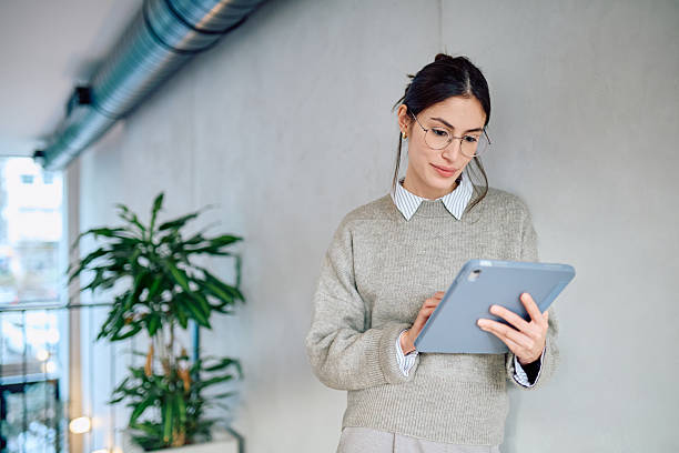 istock Young businesswoman using digital tablet in modern office 2250122688