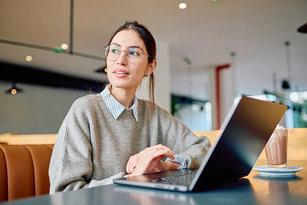 istock Woman working on laptop contemplating in cafe 2250122976