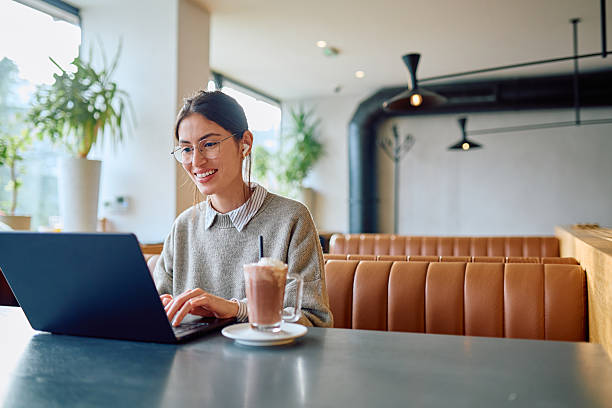istock Woman working on laptop in modern cafe 2250123123