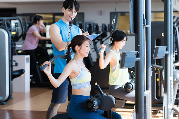 istock Men and women training at the gym 2250126736