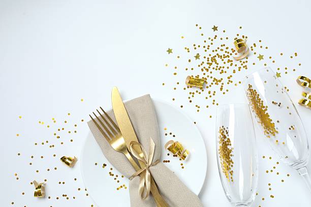 istock Festive background with champagne glasses, plate, cutlery and confetti, copy space composition 2250127975