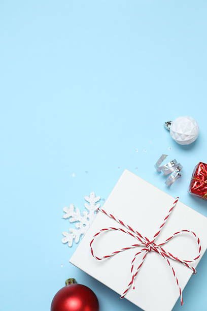 istock Beautiful gift box tied with bow and decorations on color background 2250128144