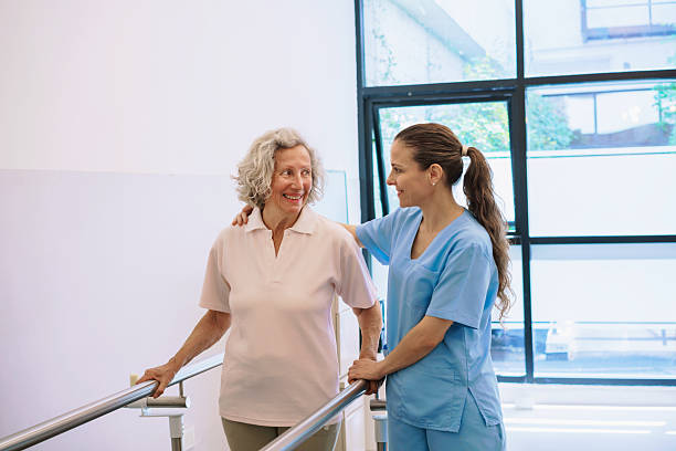 istock Physiotherapist Assists Senior During Rehabilitation Exercise Session 2250129121