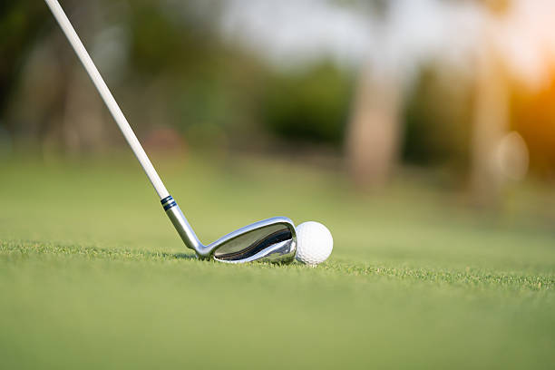 istock Golf ball and club on green grass with soft sunlight 2250129315
