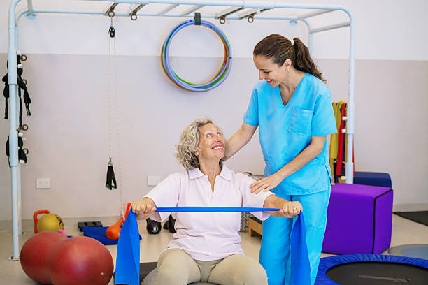 istock Compassionate Nurse Guides Senior Through Therapy Exercise 2250129408