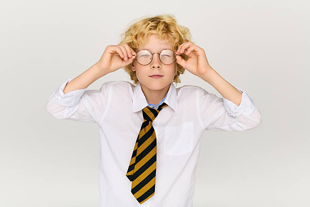 istock Blonde schoolboy with wavy hair poses confidently in a studio setting 2250130787