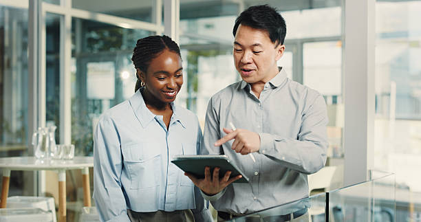istock Teamwork, conversation and business people with tablet, smile or financial advisor with internet. Employees, man or woman with tech, app or research for economy analysis or report for profit increase 2250132270